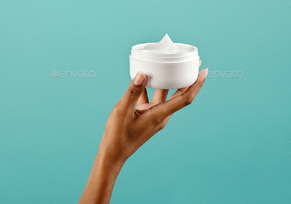 Black Woman Holding Jar Of Body Cream Stock Photo By Photology